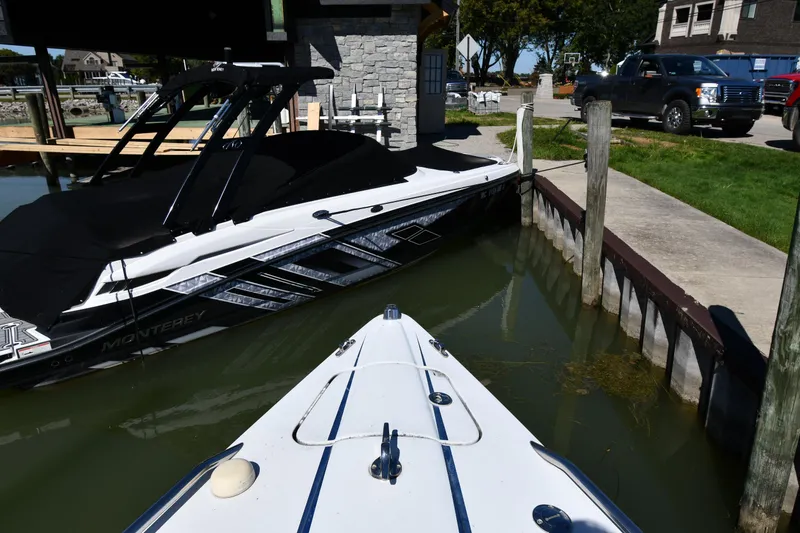 Slide: The Image of 2003 Formula 353 FASTech boat docked near a covered Monterey boat in a marina. - 3
