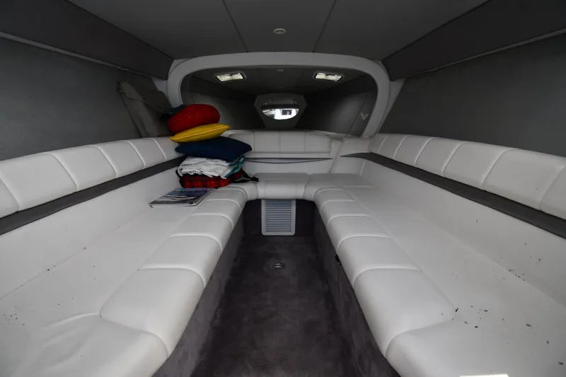 Slide: The Image of Interior of 2003 Formula 353 FASTech boat with white seating and colorful cushions. - 31