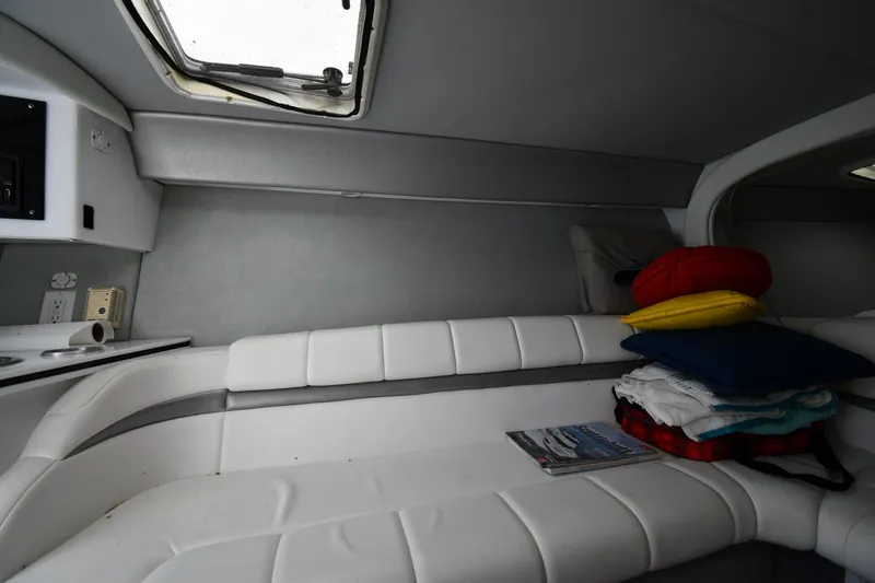 Slide: The Image of Interior cabin of a 2003 Formula 353 FASTech boat with white seating and porthole. - 32