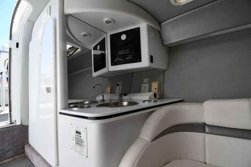 Slide: The Image of Interior of a 2003 Formula 353 FASTech boat featuring a compact kitchenette. - 38