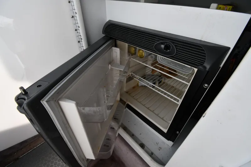 Slide: The Image of Open mini fridge inside a 2003 Formula 353 FASTech boat cabin. - 42