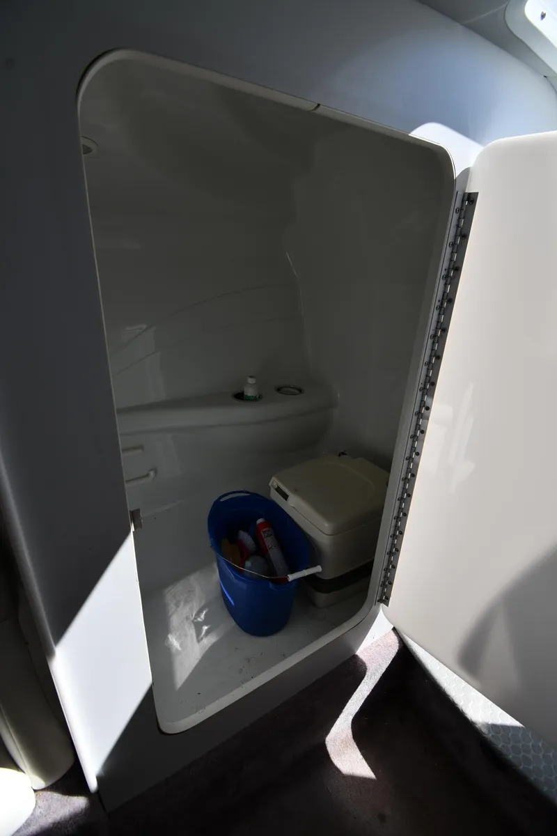Slide: The Image of 2003 Formula 353 FASTech boat interior storage compartment with cleaning supplies. - 44
