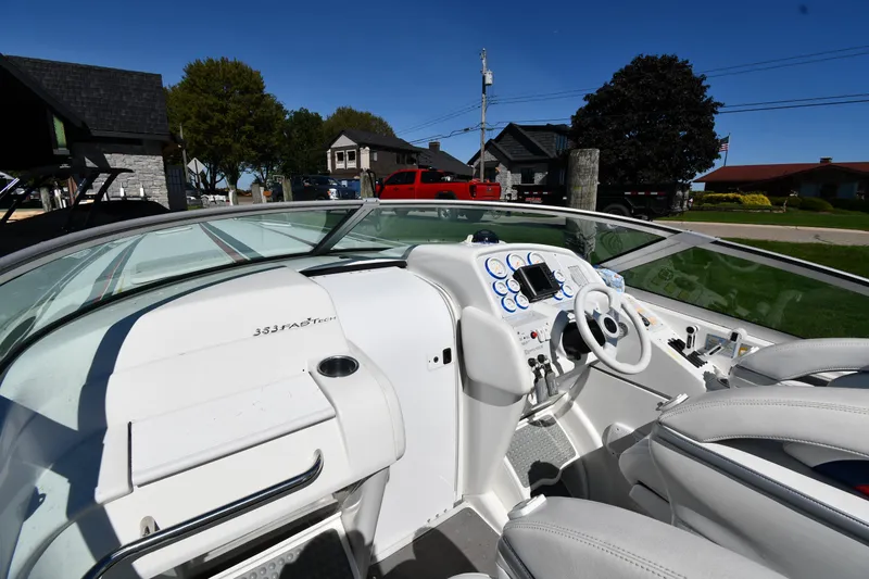 Slide: The Image of 2003 Formula 353 FASTech boat interior with white dashboard and steering wheel. - 8
