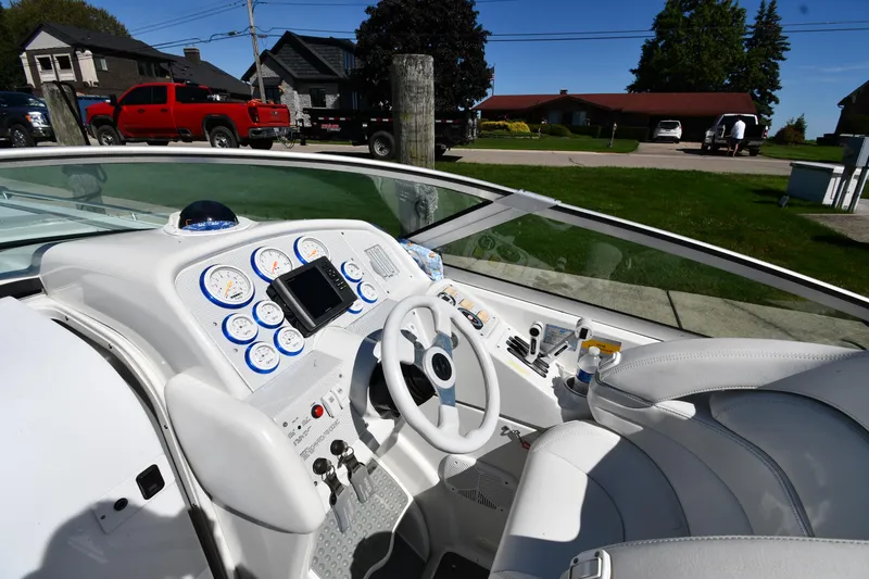 Slide: The Image of 2003 Formula 353 FASTech boat cockpit with white interior and detailed dashboard controls. - 9