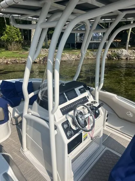 Slide: The Image of 2021 Finseeker 200 CC boat with modern helm and canopy on a calm lake. - 12