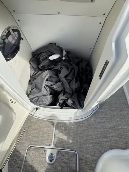 Slide: The Image of 2021 Finseeker 200 CC boat interior storage compartment with black cover. - 15