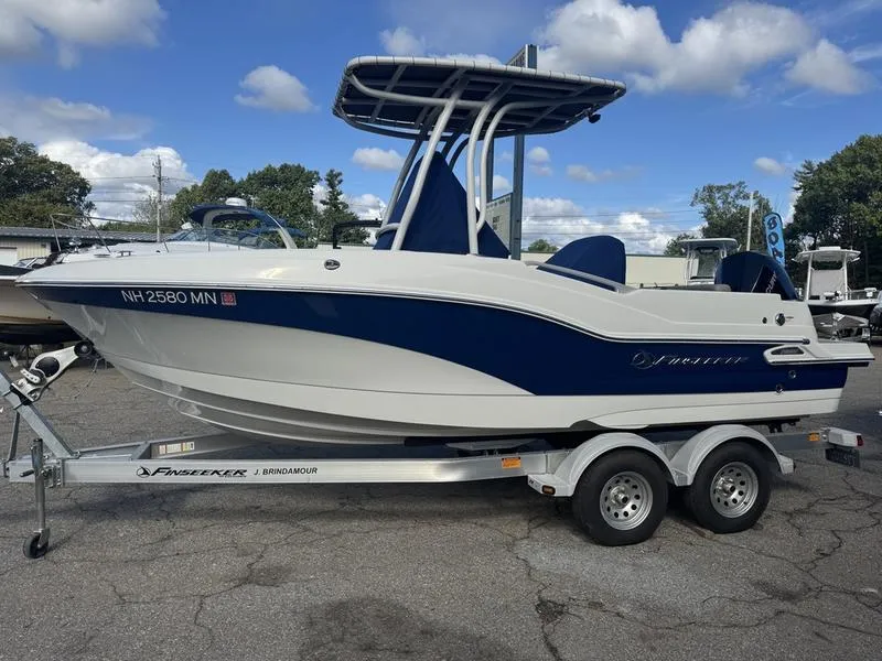Slide: The Image of 2021 Finseeker 200 CC boat on trailer, blue and white design, parked outdoors. - 16