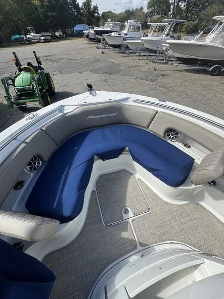 Slide: The Image of 2021 Finseeker 200 CC boat with blue seating, docked outdoors. - 18