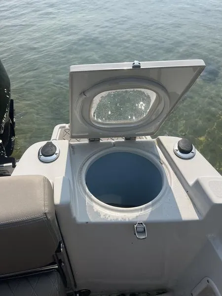 Slide: The Image of 2021 Finseeker 200 CC boat with open storage compartment on calm water. - 22