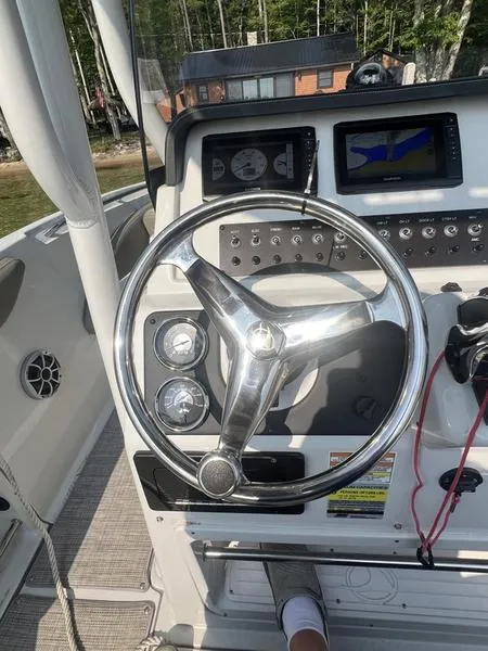 Slide: The Image of 2021 Finseeker 200 CC boat dashboard with steering wheel and navigation display. - 27