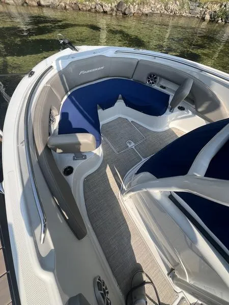 Slide: The Image of 2021 Finseeker 200 CC boat interior with blue and gray seating, docked by clear water. - 4