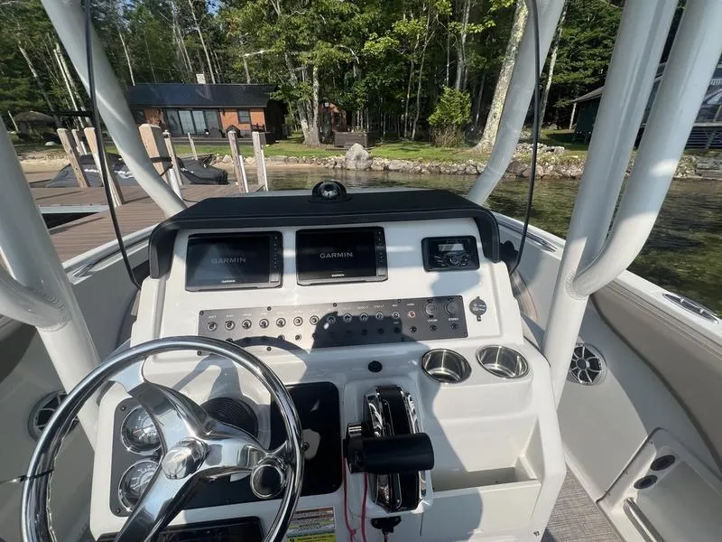 Slide: The Image of 2021 Finseeker 200 CC boat dashboard with steering wheel and navigation controls. - 5