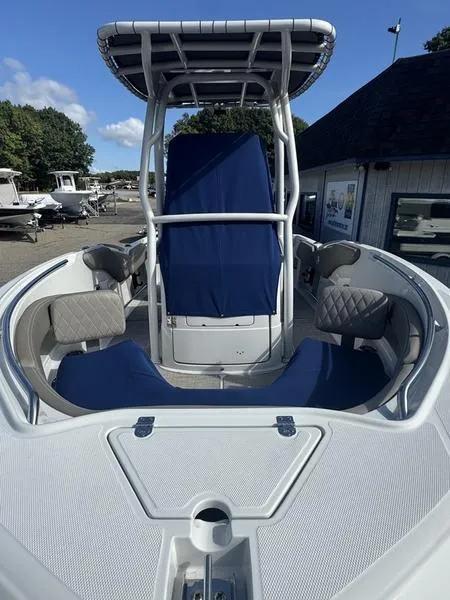 Slide: The Image of 2021 Finseeker 200 CC boat with blue seating and T-top in a marina setting. - 8