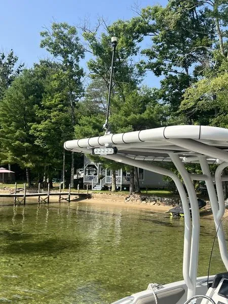Slide: The Image of 2021 Finseeker 200 CC boat near a lakeside dock with trees. - 9