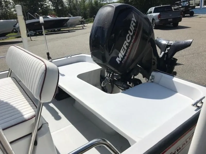 Slide: The Image of 1995 Boston Whaler 150 Dauntless boat with Mercury outboard motor, parked outdoors. - 12