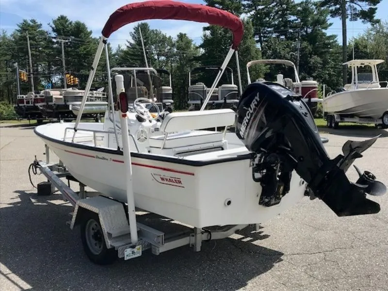Slide: The Image of 1995 Boston Whaler 150 Dauntless boat on trailer with Mercury outboard motor. - 2