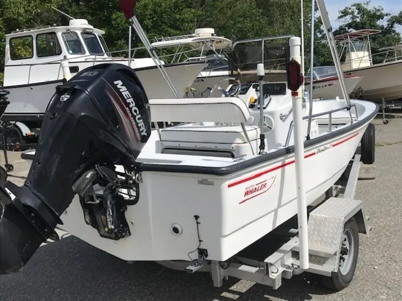 Slide: The Image of 1995 Boston Whaler 150 Dauntless boat with Mercury outboard motor on trailer. - 5