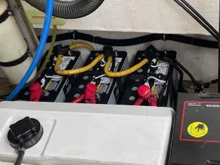 Slide: The Image of Battery compartment of a 2000 Pursuit 3400 Express boat with connected cables. - 10