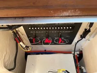 Slide: The Image of Electrical panel inside a 2000 Pursuit 3400 Express boat, featuring switches and wiring. - 17