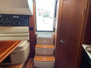 Slide: The Image of Interior of 2000 Pursuit 3400 Express boat with wooden steps and control panel. - 19