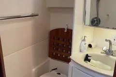 Slide: The Image of Bathroom interior of 2000 Pursuit 3400 Express boat, featuring sink and toilet. - 20