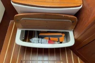 Slide: The Image of Storage compartment in 2000 Pursuit 3400 Express boat with wooden interior. - 21