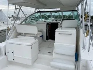 Slide: The Image of 2000 Pursuit 3400 Express boat interior with seating and helm, docked at marina. - 4