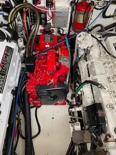 Slide: The Image of Engine room of a 2000 Pursuit 3400 Express boat, featuring red and white machinery. - 8