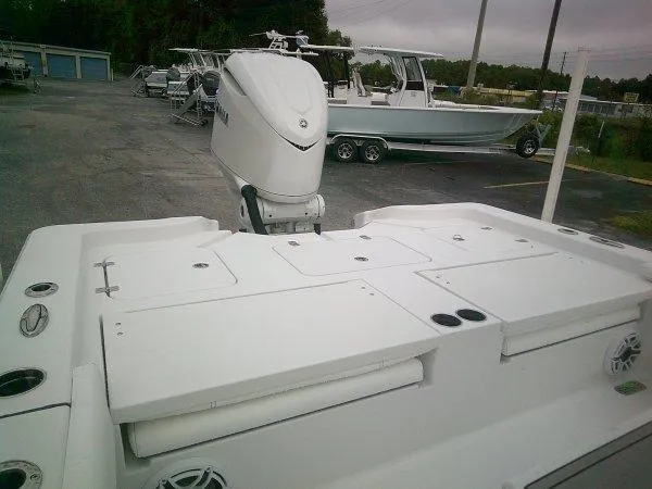 Slide: The Image of 2025 Sportsman 267 Masters boat with outboard motor in a parking lot. - 2