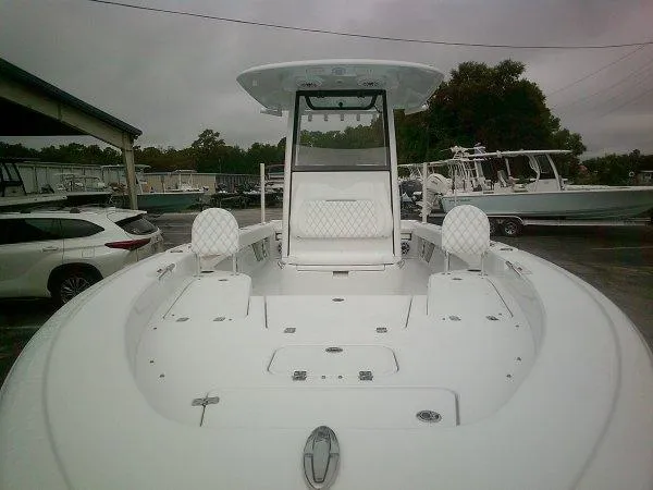 Slide: The Image of 2025 Sportsman 267 Masters boat, spacious deck, white interior, parked outdoors. - 5