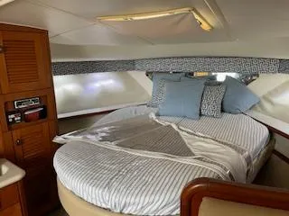 Slide: The Image of Interior of a 2000 Pursuit 3400 Express yacht with cozy bed. - 16