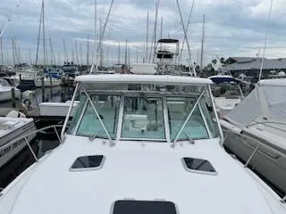 Slide: The Image of Pursuit 3400 Express 2000 in harbor, surrounded by sailboats. - 7