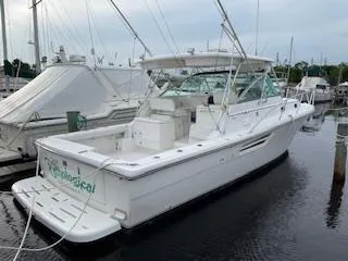 Slide: The Image of Pursuit 3400 Express 2000, white boat docked in marina. - 8