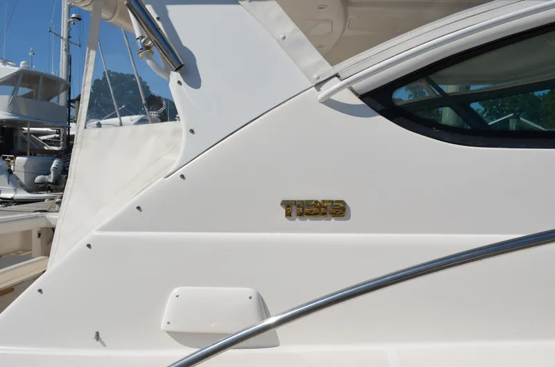 Slide: The Image of 2004 Tiara Yachts 3800 Open, side view with logo and window detail. - 10