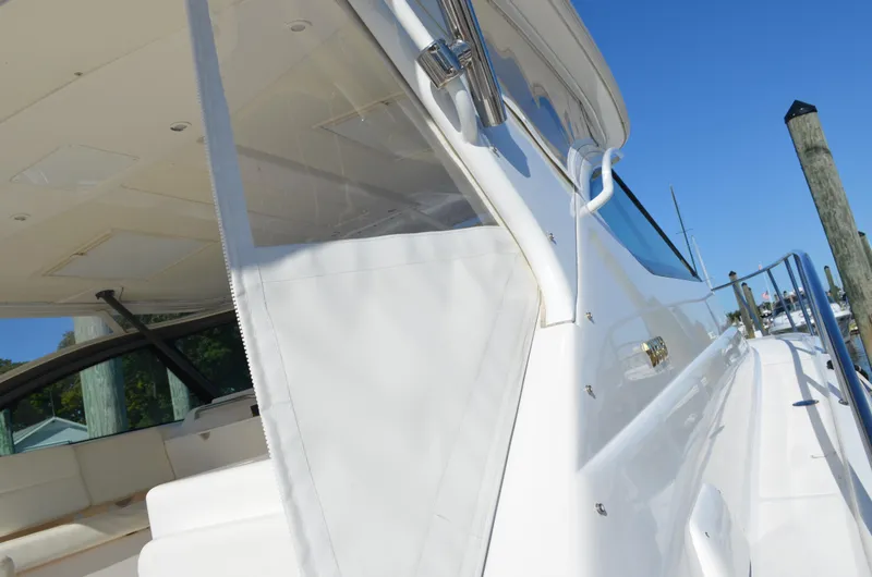 Slide: The Image of 2004 Tiara Yachts 3800 Open, sleek white exterior, docked under clear blue sky. - 11