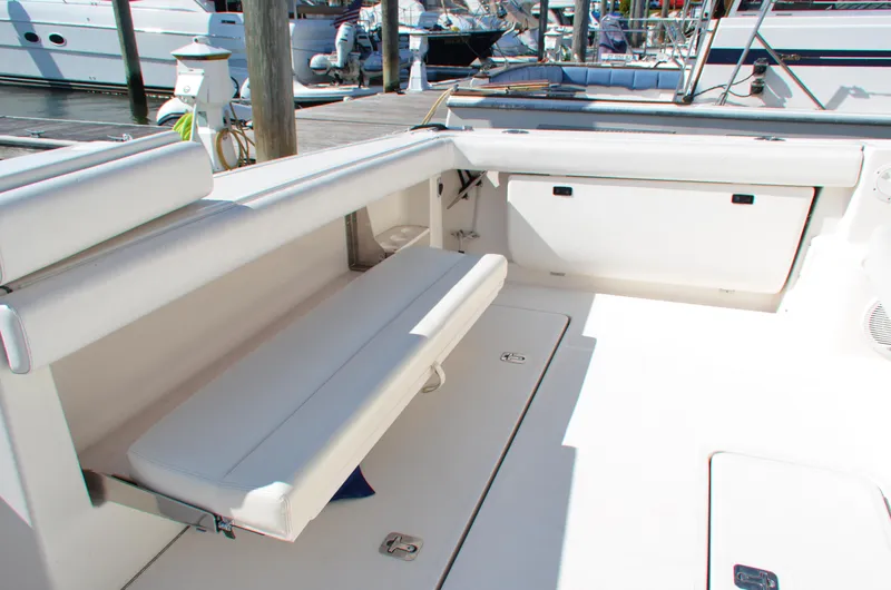 Slide: The Image of 2004 Tiara Yachts 3800 Open interior with white seating and storage compartments. - 18