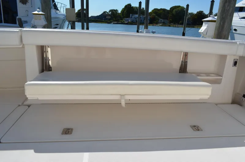 Slide: The Image of 2004 Tiara Yachts 3800 Open boat seating area with foldable bench. - 19