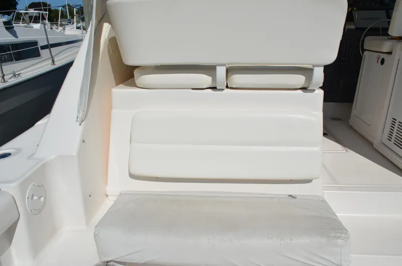 Slide: The Image of 2004 Tiara Yachts 3800 Open interior seating area with white cushions. - 26