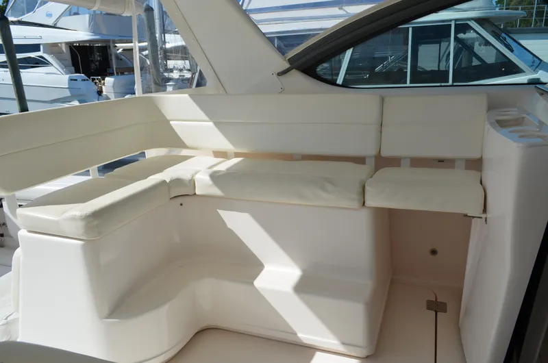 Slide: The Image of 2004 Tiara Yachts 3800 Open interior seating area with white cushions. - 28