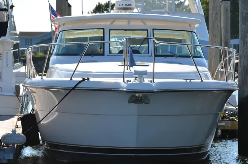 Slide: The Image of 2004 Tiara Yachts 3800 Open docked, front view with American flag. - 3