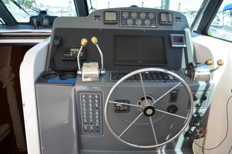 Slide: The Image of 2004 Tiara Yachts 3800 Open helm with steering wheel and control panel. - 33