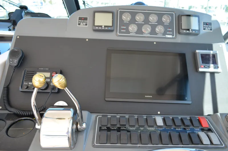 Slide: The Image of 2004 Tiara Yachts 3800 Open helm with controls, gauges, and Garmin display. - 35