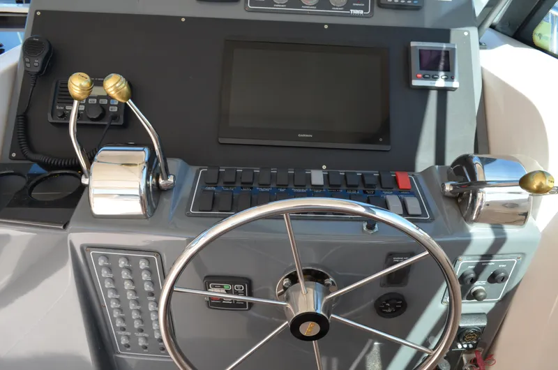 Slide: The Image of Dashboard of a 2004 Tiara Yachts 3800 Open with steering wheel and controls. - 36