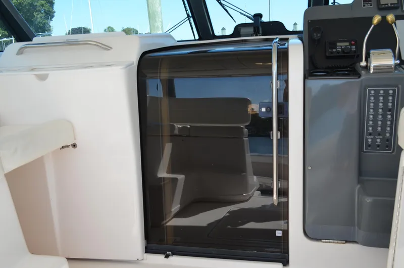 Slide: The Image of 2004 Tiara Yachts 3800 Open cabin entrance with control panel and seating area. - 38