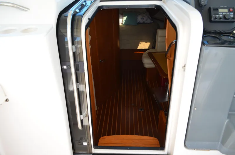 Slide: The Image of Interior view of 2004 Tiara Yachts 3800 Open, featuring wooden flooring and seating area. - 39