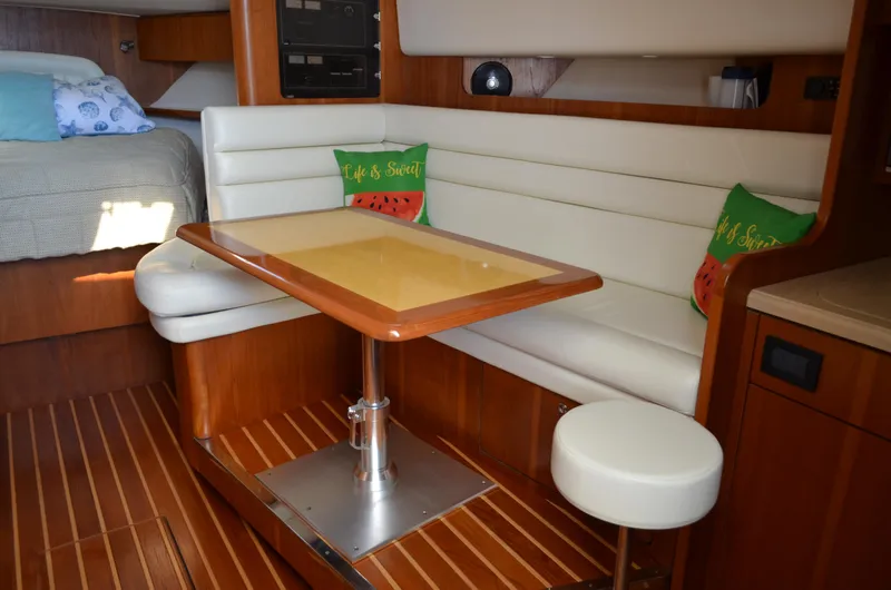 Slide: The Image of 2004 Tiara Yachts 3800 Open interior with dining area and cozy seating. - 40