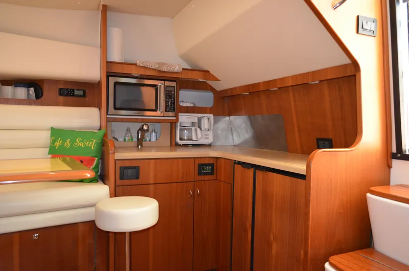 Slide: The Image of 2004 Tiara Yachts 3800 Open interior with kitchenette and seating area. - 44