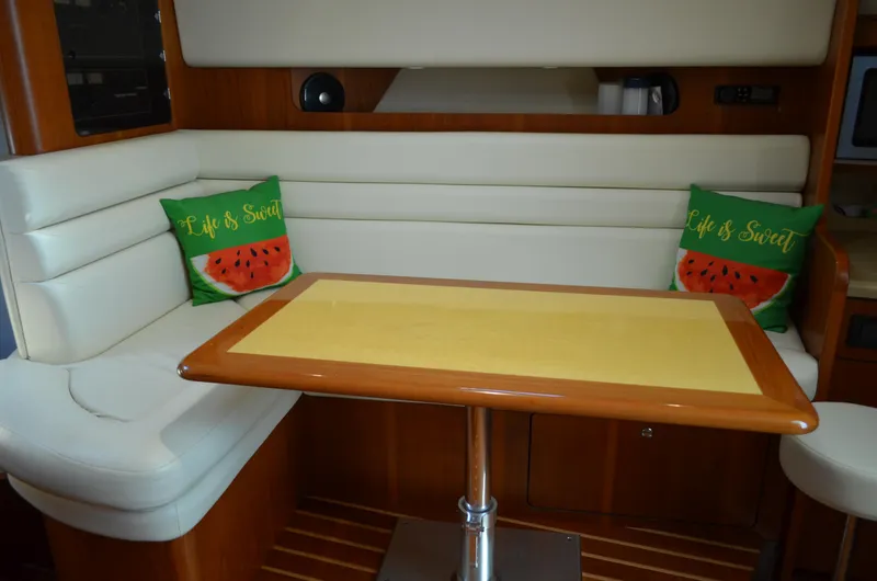 Slide: The Image of 2004 Tiara Yachts 3800 Open interior with cozy seating and decorative pillows. - 45