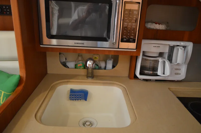 Slide: The Image of 2004 Tiara Yachts 3800 Open kitchen with sink, microwave, and coffee maker. - 47
