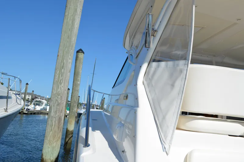 Slide: The Image of 2004 Tiara Yachts 3800 Open docked at marina under clear blue sky. - 7